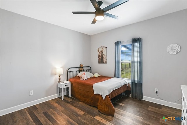 bedroom with ceiling fan, baseboards, and wood finished floors