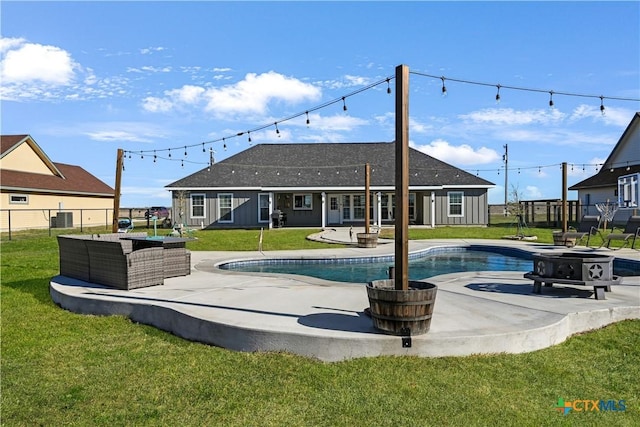 pool featuring a lawn, a patio, fence, french doors, and a fire pit