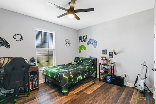 bedroom with ceiling fan, baseboards, and wood finished floors