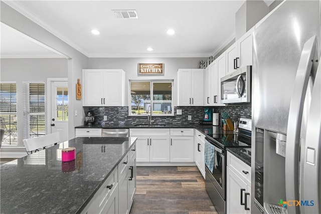 kitchen featuring crown molding, visible vents, appliances with stainless steel finishes, and a sink