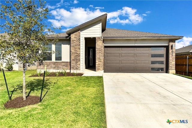 view of front facade featuring a garage and a front lawn