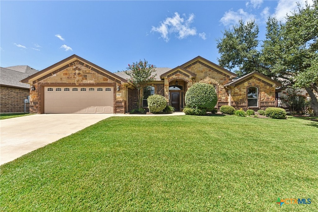 single story home with a garage and a front lawn