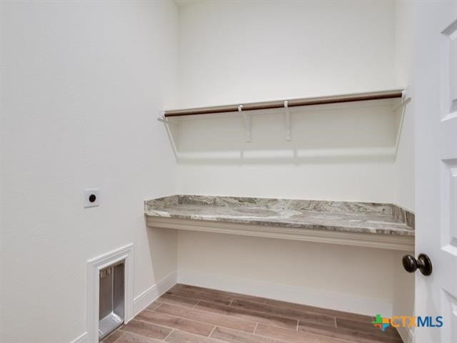 laundry room featuring hookup for an electric dryer and light hardwood / wood-style floors