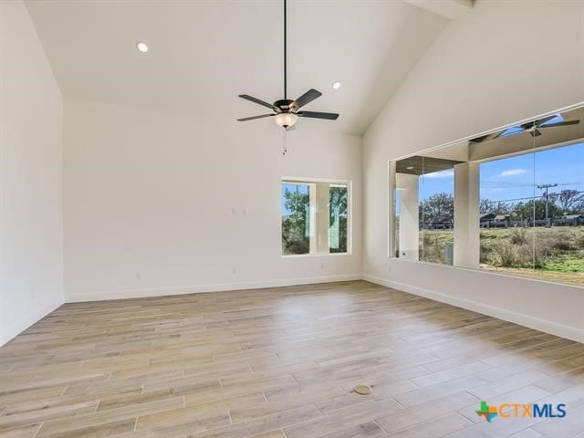 unfurnished room with beamed ceiling, ceiling fan, high vaulted ceiling, and light hardwood / wood-style flooring