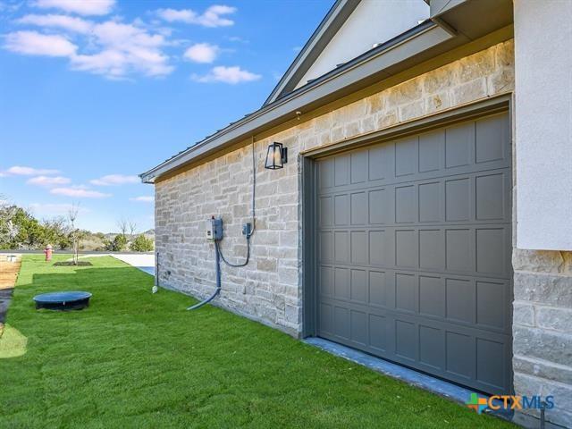 view of home's exterior featuring a garage and a yard