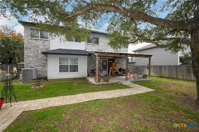 rear view of house with a patio, a yard, central AC, and a pergola