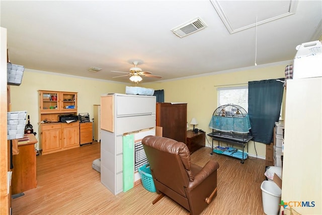 living room featuring crown molding, light hardwood / wood-style floors, and ceiling fan