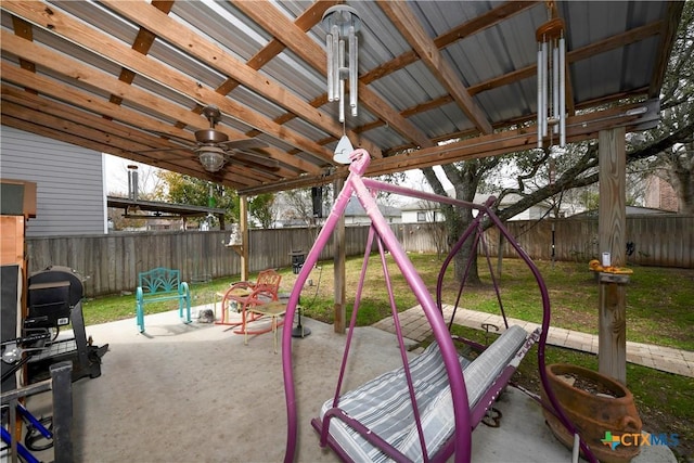 view of play area with ceiling fan, a patio, and a lawn