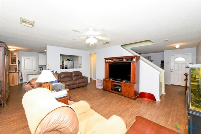 living room with ceiling fan and dark hardwood / wood-style floors