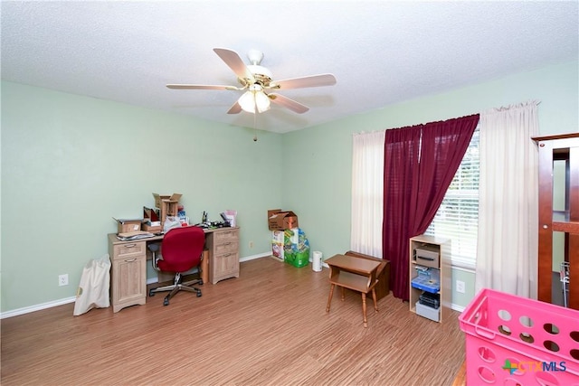 office area featuring ceiling fan, a textured ceiling, and light wood-type flooring