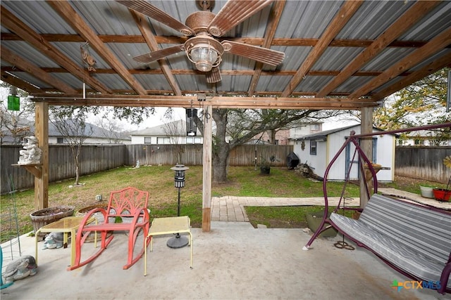 view of patio featuring an outbuilding and ceiling fan