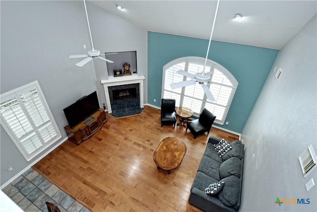 1320 Becca Teal Pl, Round Rock, TX 78681 - living area featuring a high end fireplace, baseboards, a ceiling fan, and wood finished floors