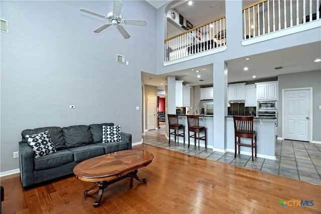 1320 Becca Teal Pl, Round Rock, TX 78681 - living area featuring light wood-type flooring, visible vents, baseboards, and ceiling fan