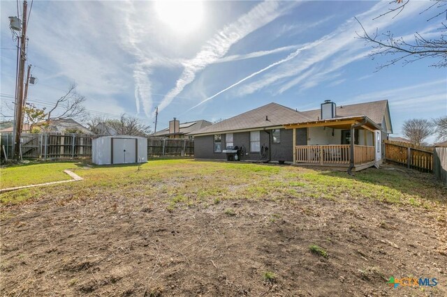 204 Paula St, Copperas Cove, TX 76522 - rear view of property featuring an outbuilding, a yard, a fenced backyard, and a shed