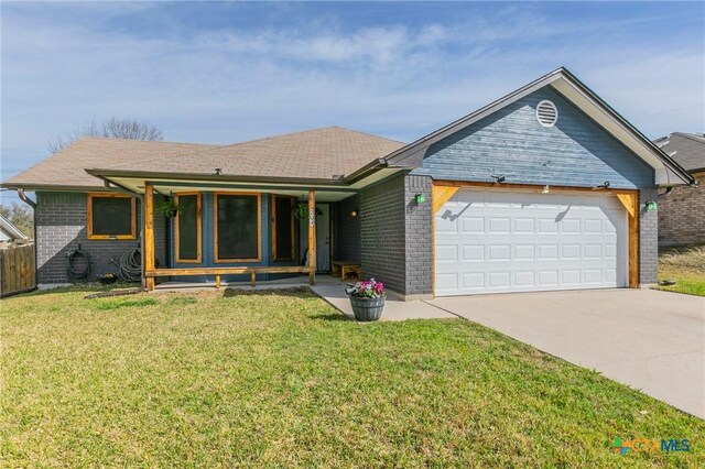 204 Paula St, Copperas Cove, TX 76522 - ranch-style house with a front yard, an attached garage, brick siding, and concrete driveway