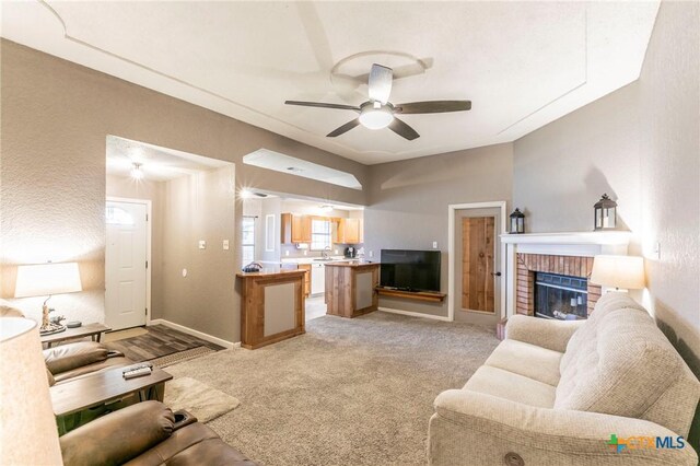 204 Paula St, Copperas Cove, TX 76522 - living area with baseboards, light carpet, a fireplace, and a ceiling fan