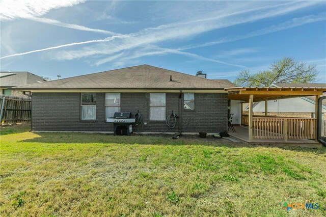 204 Paula St, Copperas Cove, TX 76522 - back of property featuring a yard, brick siding, and fence