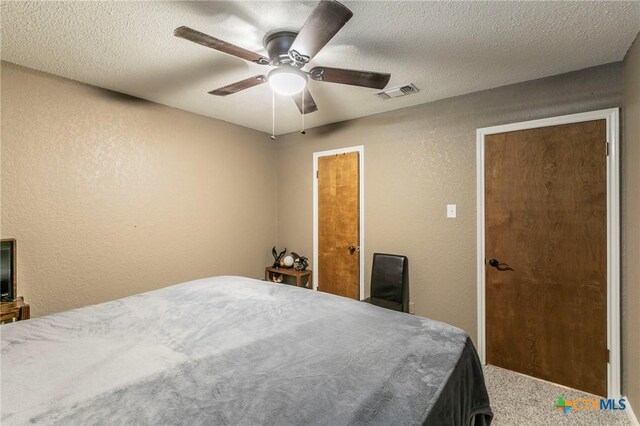 204 Paula St, Copperas Cove, TX 76522 - carpeted bedroom featuring a textured wall, visible vents, and a textured ceiling