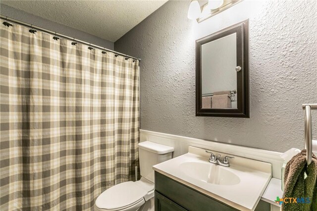 204 Paula St, Copperas Cove, TX 76522 - bathroom with vanity, toilet, a textured wall, and a textured ceiling