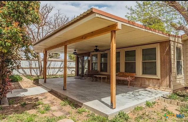 view of patio with a ceiling fan and fence