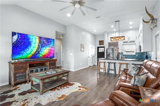 living area with dark wood-style floors, baseboards, a ceiling fan, and visible vents