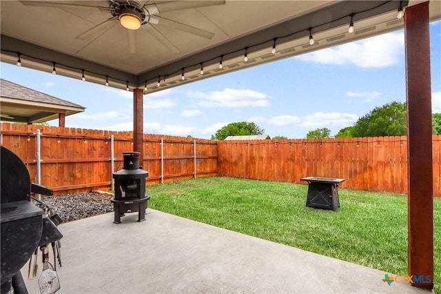 view of patio with a fenced backyard, ceiling fan, and area for grilling