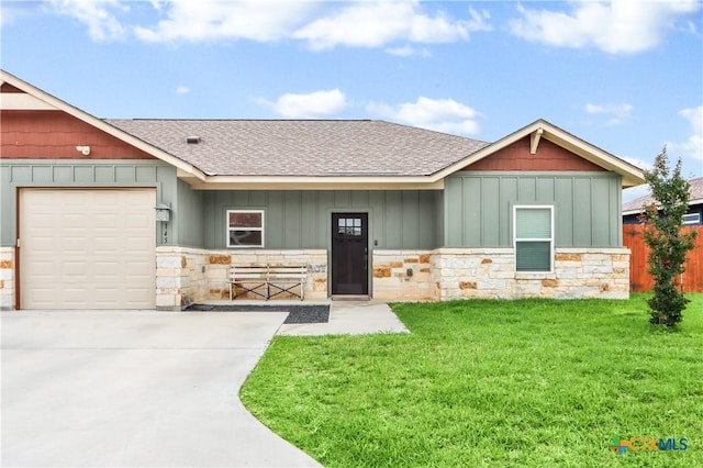 craftsman-style house with a shingled roof, a front lawn, and stone siding