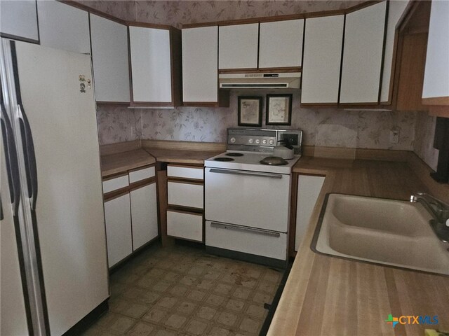 kitchen with white cabinetry, white appliances, and sink