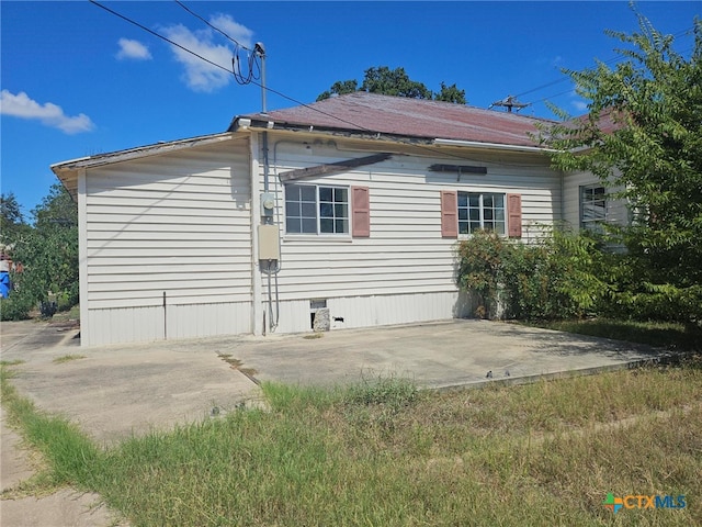 view of side of home with a patio