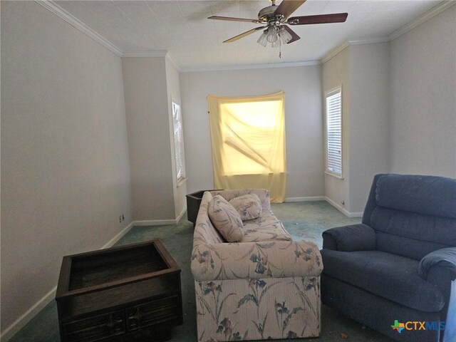 sitting room with carpet floors, ceiling fan, and crown molding