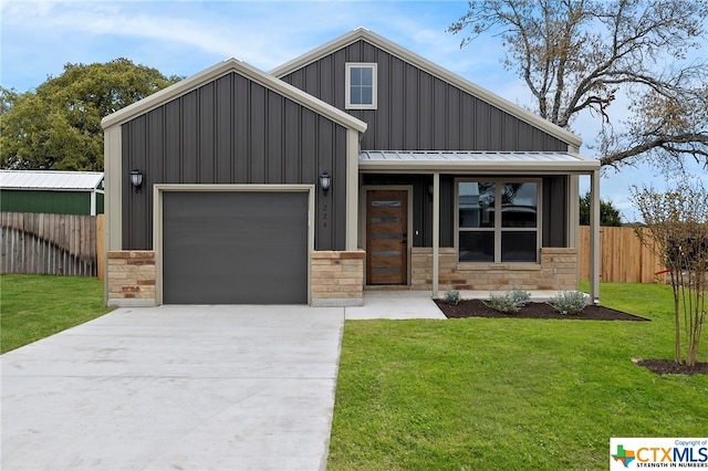 view of front of home with a front yard and a garage