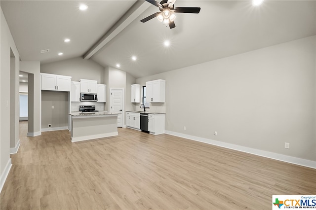 kitchen featuring light wood-type flooring, stainless steel appliances, lofted ceiling with beams, white cabinets, and a center island