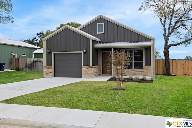 view of front of property featuring a garage and a front lawn