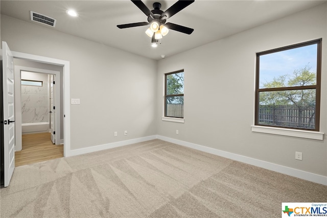 carpeted empty room featuring ceiling fan