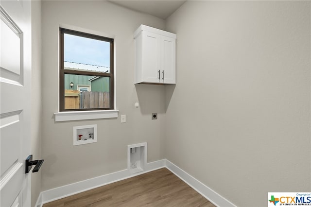 clothes washing area featuring hookup for an electric dryer, cabinets, wood-type flooring, and washer hookup