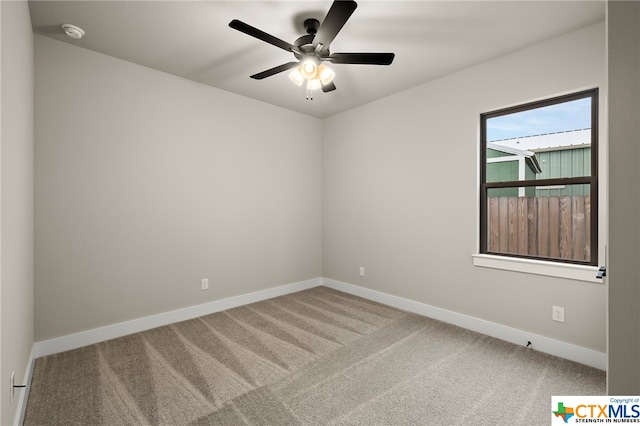 unfurnished room featuring ceiling fan and carpet floors