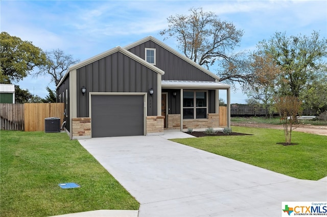 view of front facade with central AC unit, a garage, and a front lawn