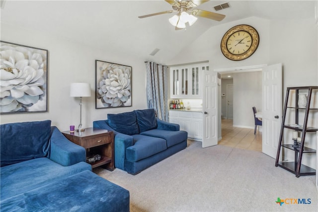 living room with vaulted ceiling, light colored carpet, and ceiling fan