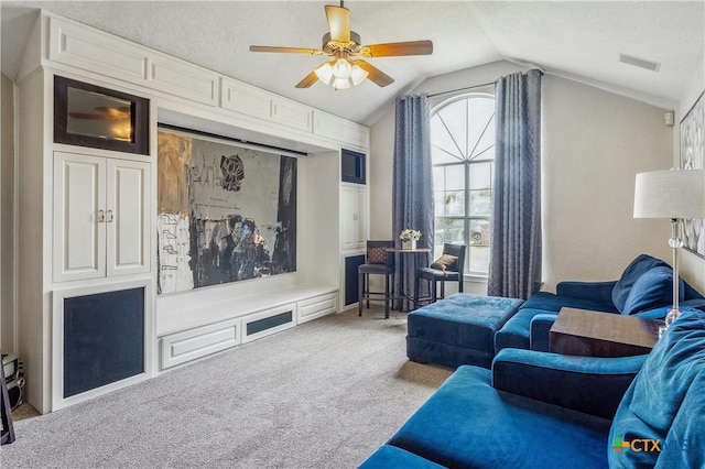 carpeted living room featuring a textured ceiling, lofted ceiling, and ceiling fan