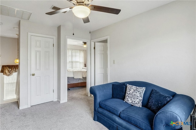 living room featuring light colored carpet and ceiling fan