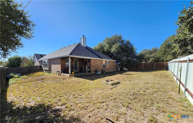 back of house with a lawn