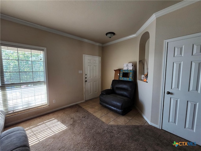 sitting room with light colored carpet, a textured ceiling, and ornamental molding