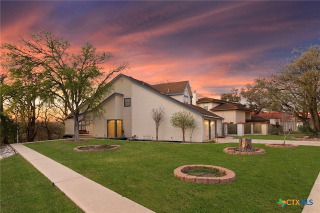 view of front of home with a front lawn and a fire pit