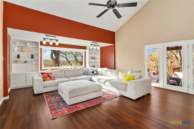 living area featuring built in features, a ceiling fan, dark wood-type flooring, and high vaulted ceiling