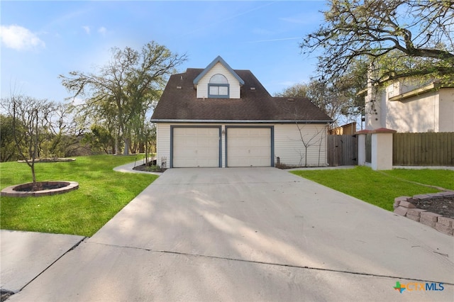 exterior space with driveway, a front yard, and fence