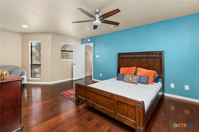 bedroom featuring visible vents, baseboards, a ceiling fan, and hardwood / wood-style flooring