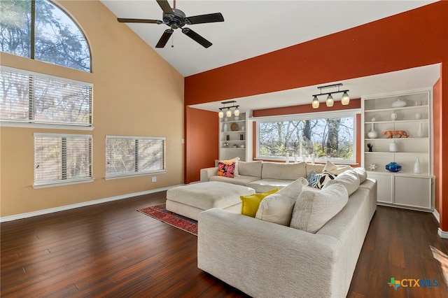 living area with high vaulted ceiling, a ceiling fan, built in features, baseboards, and dark wood-style flooring