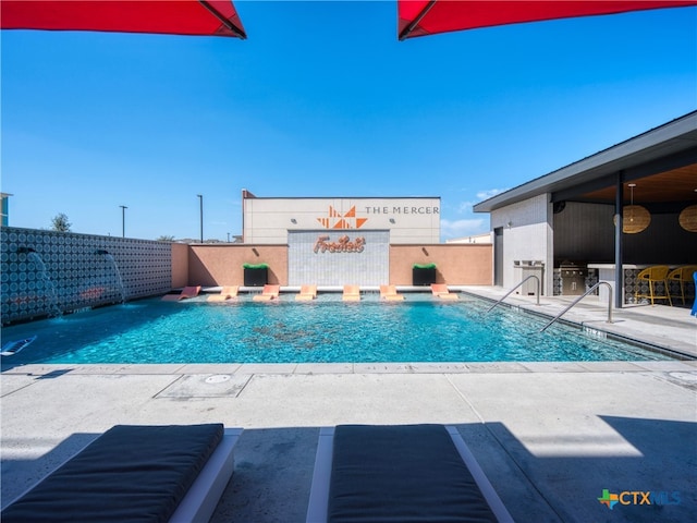 view of pool featuring a patio area, fence, and a fenced in pool