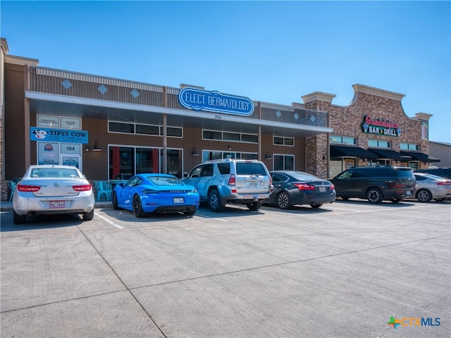 view of building exterior with uncovered parking