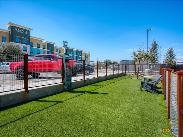 view of parking featuring fence